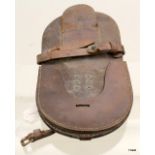 A WW1 horseshoe carrier with integral frog for sword or bayonet. Stamped to the nail pouch J