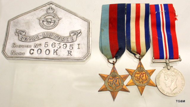 An aluminium Royal Air Force bed plate named to 563951 R Cook with his WW2 mounted medal trio