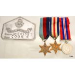 An aluminium Royal Air Force bed plate named to 563951 R Cook with his WW2 mounted medal trio