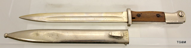 A WW2 chrome plated German parade bayonet with its original scabbard. The sabbard is marked EUF