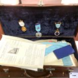 A leather case with miscellaneous Masonic items including medals