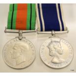 A mounted WW2 Defence Medal with a Police Long Service & Good Conduct Medal named to Sergeant John