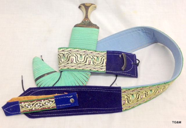 An Arab curved dagger with horn handle and decorative belt
