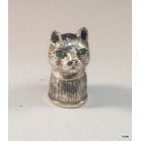 A silver cat pin cushion