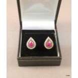 A pair of silver Cz and garnet teardrop shaped earrings