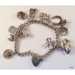 A silver charm bracelet together with 13 charms 45gm