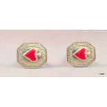 A pair of silver and heart shaped enamel cufflinks