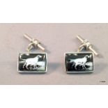 A pair of silver and enamel set cufflinks depicting retriever dogs