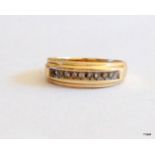 A 9ct gold diamond channel set ring size M