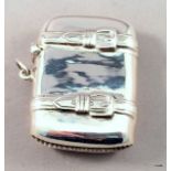 A silver Vesta case in the form of a suitcase