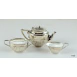 A silver miniature three piece tea set