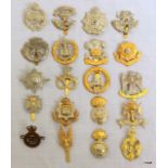 A quantity of assorted military cap badges