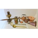 A collection of brass and copper items to include vintage plant sprayer, beer warming jug, oil