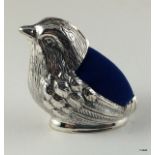 A silver pin cushion in the form of a Wren