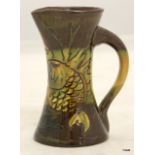 C.H Brannon pottery jug with fish decoration 11cm high