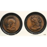 Pair of ornate cast iron wall plates, classical heads, 26.5cm diameter