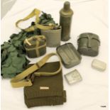 An assortment of military items including Camouflage Netting, Rifle Sling, Water Bottles, Mess