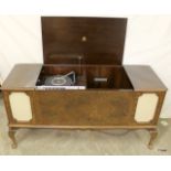 A mahogany Dynatron Radiogram Ltd with built in speakers  and paperwork 73 x 147 x 51cm