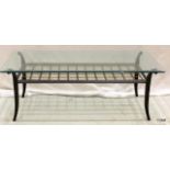 A glass tipped wrought iron coffee table 45 x 124 x 60cm