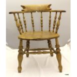 A large pine spindle back captain's chair