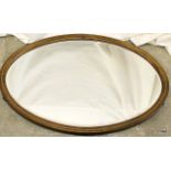 A mahogany inlaid oval mirror 79 x 54cm