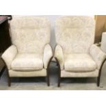 A pair of wooden framed reclining chairs