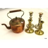 A copper Kettle, 2 x brass candlesticks and 2 x silver plated candle sticks