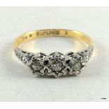 An 18ct gold and platinum set 3 stone diamond ring size O