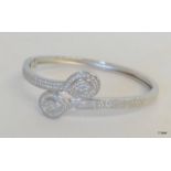 A Silver and CZ Bangle of Interlocking Pear Shaped CZ's.