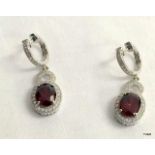 A Pair of Silver CZ and Garnet Drop Earrings.