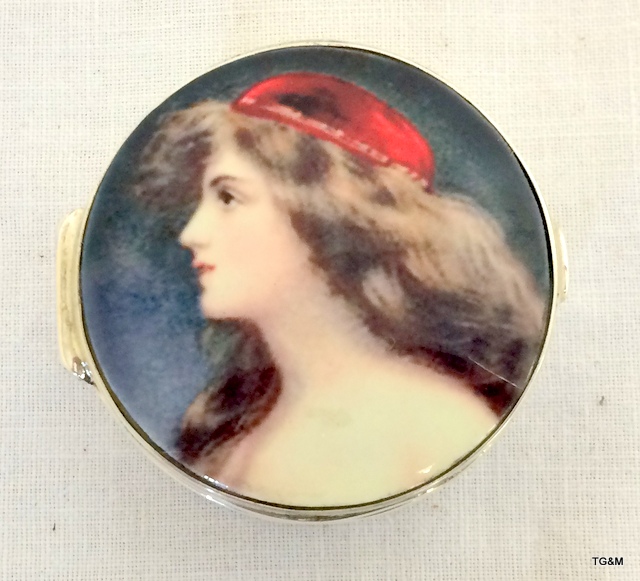 A silver ring box with pictorial enamel image