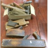 A collection of old woodworking planes and drill bits