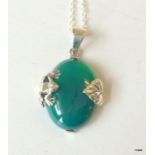 A silver and jade pendant necklace on silver chain
