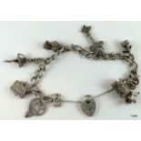 Silver charm bracelet and 7 charms 33gm