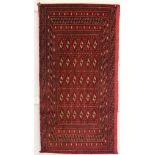 A Red Torkaman rug 120 x 60cm