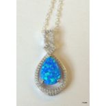 A silver cz and blue opal drop pendant necklace on silver chain