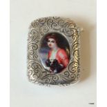 A silver plated vesta case with enamel images to each side