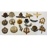 An assortment of military cap badges and shoulder titles