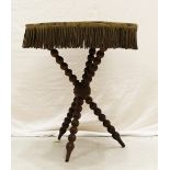 A cloth covered cricket table on turned tripod legs 68 x 56 x 56cm