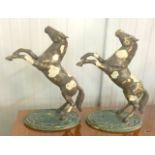 A pair of metal rearing horses