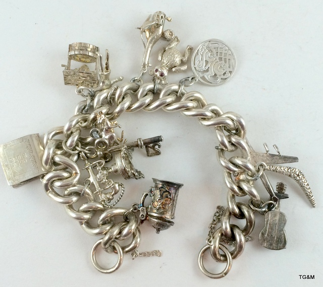 Silver charm bracelet and 13 charms 89gm