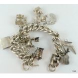 Silver charm bracelet and 13 charms 89gm