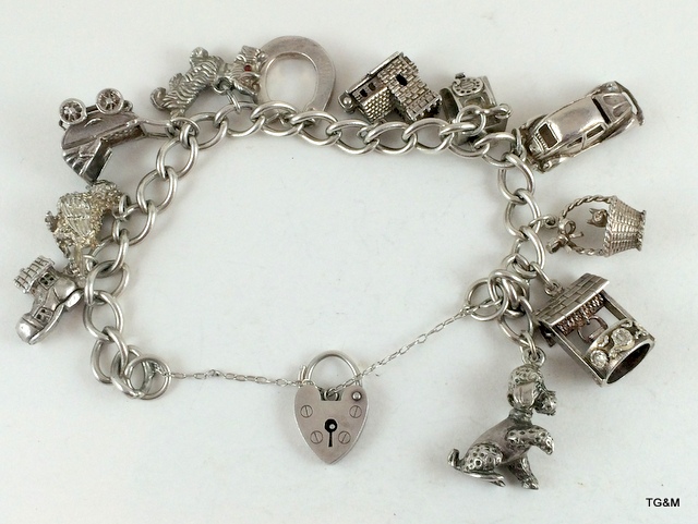 Silver charm bracelet and 11 charms 58gm