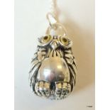 A silver owl pendant necklace with glass eyes on silver chain