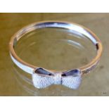 A silver and cz bangle set with a bow
