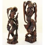 Two hand carved Coromandel wood figures of Asian ladies each with a bird on her head. The tallest