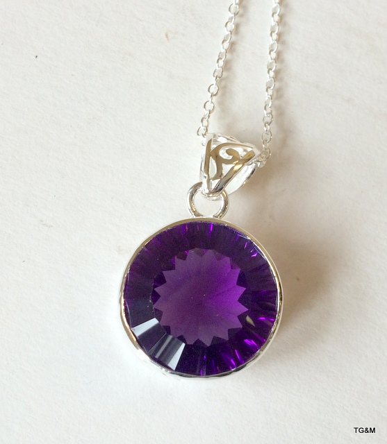 A silver and amethyst pendant necklace on silver chain