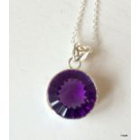 A silver and amethyst pendant necklace on silver chain