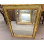 A gilt framed mirror with bamboo effect frame with bevel edged glass 95 x 65cm