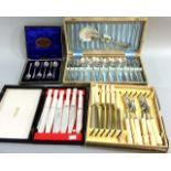 A boxed set of silver teaspoons and silver plated cutlery